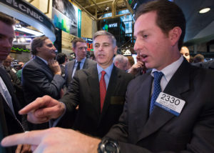 Hilton Worldwide President and Chief Executive Officer Christopher J. Nassetta in the center of the trading crowd as the company's stock opens for trading on the NYSE on Thursday, December 12. Traders wore Hilton Worldwide bathrobes.